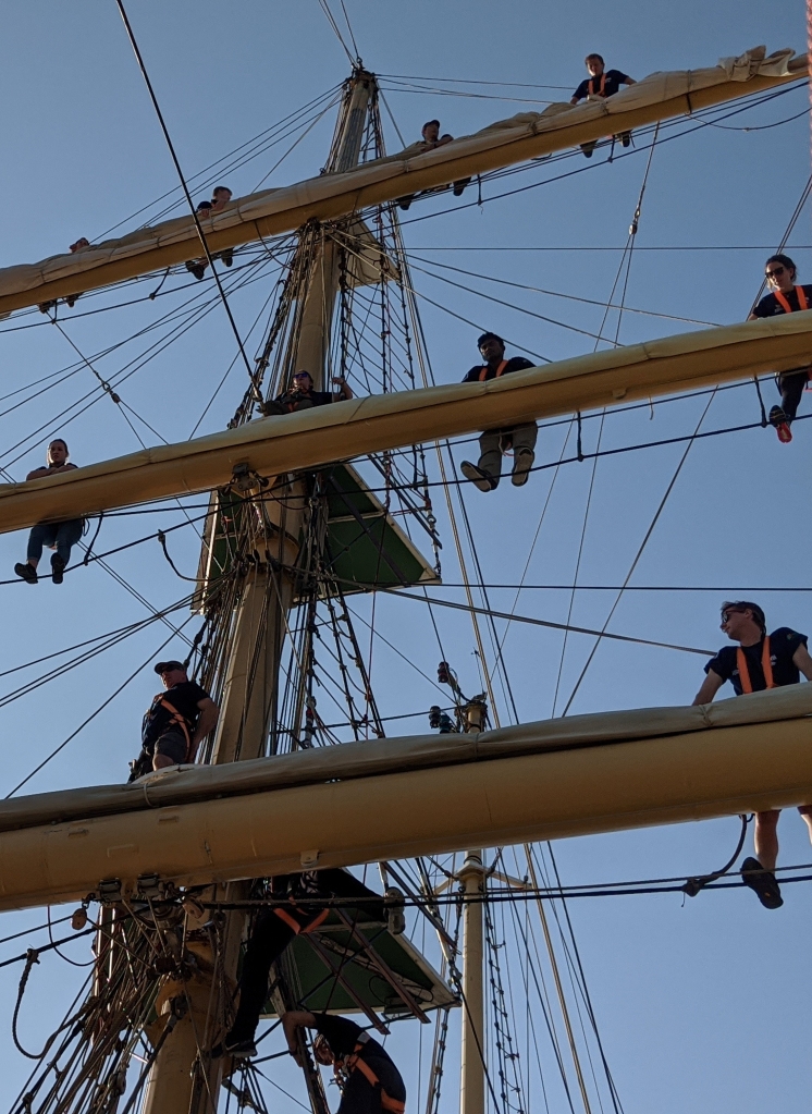 Young sail trainees on the yards of the Pelican of London
